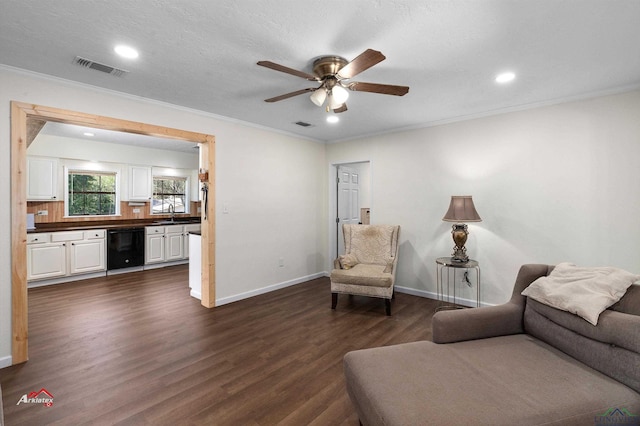 living room featuring sink, crown molding, ceiling fan, a textured ceiling, and dark hardwood / wood-style flooring