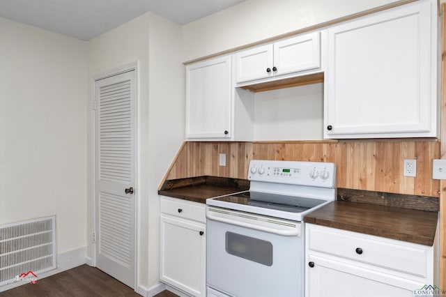 kitchen with dark hardwood / wood-style flooring, white cabinetry, and white range with electric cooktop