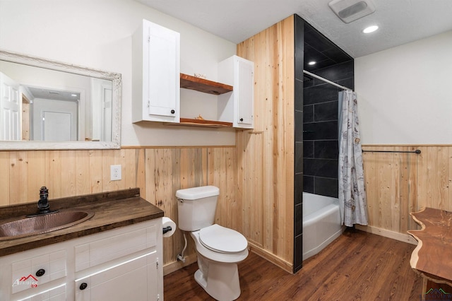 full bathroom featuring toilet, wooden walls, vanity, shower / tub combo, and hardwood / wood-style flooring