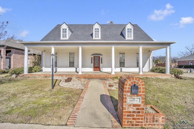 view of front of home with a porch and a front lawn