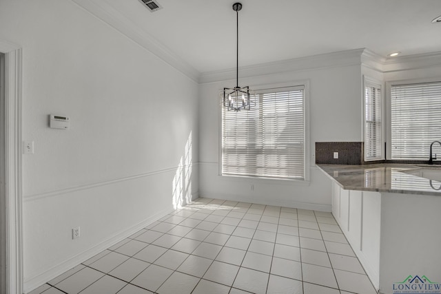 unfurnished dining area with light tile patterned flooring, a chandelier, and ornamental molding