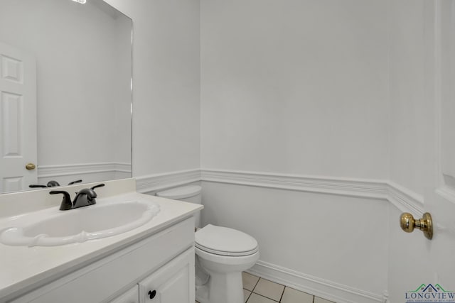 bathroom with tile patterned flooring, vanity, and toilet