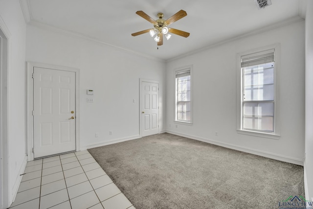 spare room with light tile patterned floors, ceiling fan, and ornamental molding