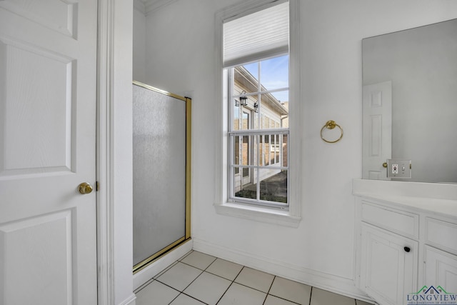 bathroom featuring tile patterned flooring, vanity, and a shower with shower door