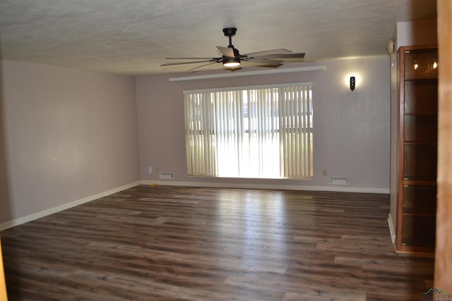 empty room with dark hardwood / wood-style flooring and ceiling fan