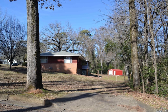 view of property exterior with a garage and an outdoor structure