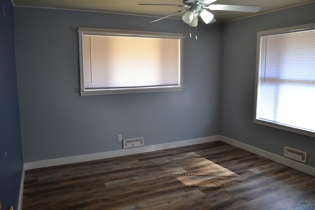 unfurnished room with dark wood-type flooring and ceiling fan