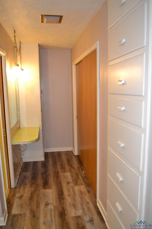 hallway with dark hardwood / wood-style floors