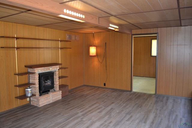 unfurnished living room featuring hardwood / wood-style floors, wood ceiling, and wood walls