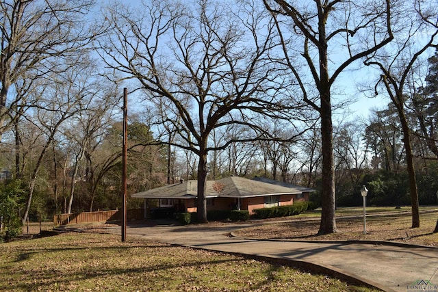 view of front facade with a carport and a front yard