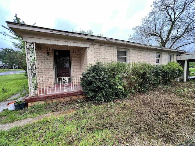 242 E Main St, Van, TX 75790 - view of property exterior featuring brick siding and covered porch