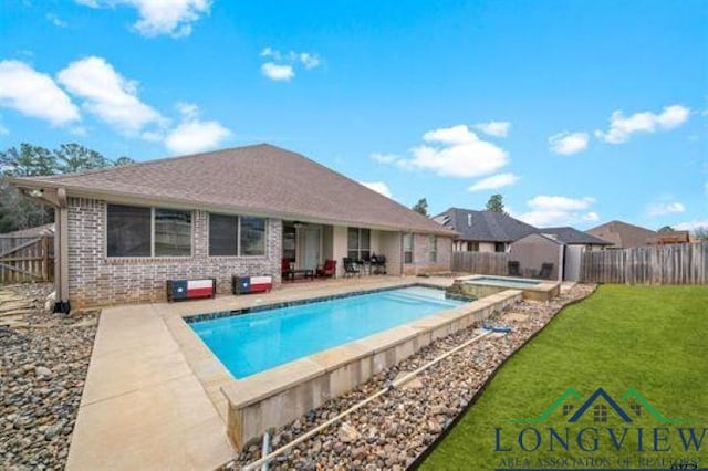 view of pool with a pool with connected hot tub, a fenced backyard, a patio area, and a yard