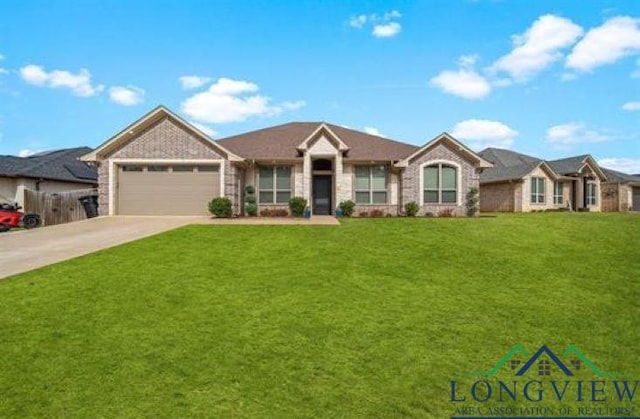 ranch-style home with concrete driveway, a garage, and a front yard