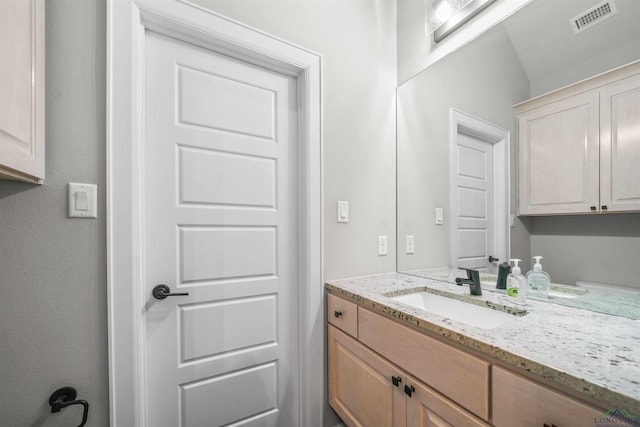 bathroom featuring visible vents and vanity