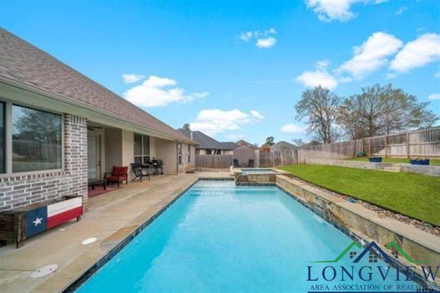 view of pool with a fenced backyard, a yard, a patio, and a pool with connected hot tub