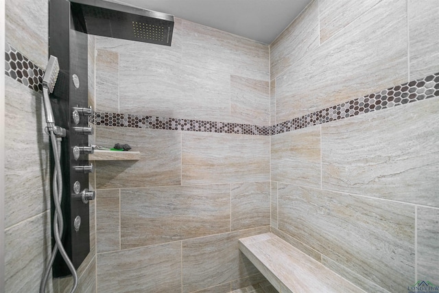 bathroom with a tile shower