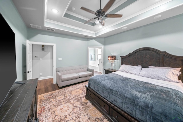 bedroom with ceiling fan, a raised ceiling, visible vents, and dark wood-style flooring