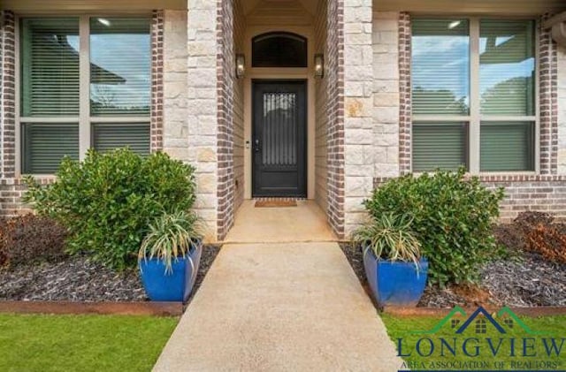 entrance to property with brick siding and stone siding