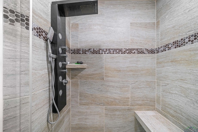 full bath featuring tiled shower