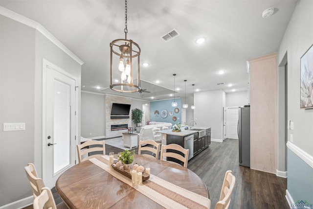 dining space with recessed lighting, visible vents, baseboards, a fireplace, and dark wood-style flooring