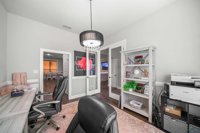 office space with visible vents, french doors, an inviting chandelier, and wood finished floors