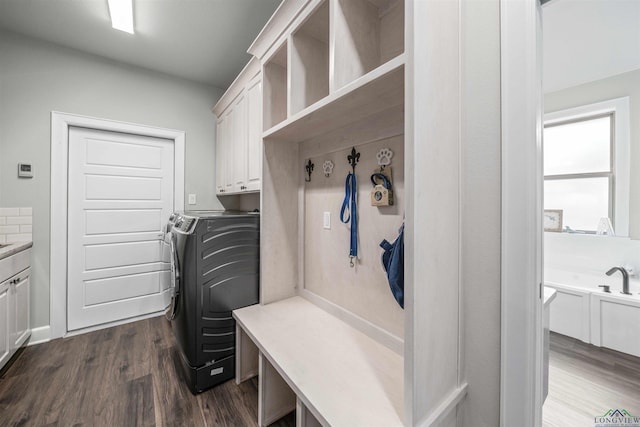 mudroom with dark wood-style floors and separate washer and dryer