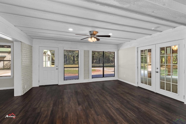 unfurnished sunroom featuring beamed ceiling, ceiling fan, and french doors