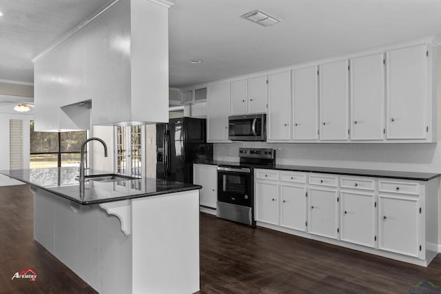 kitchen with kitchen peninsula, stainless steel appliances, white cabinetry, and sink