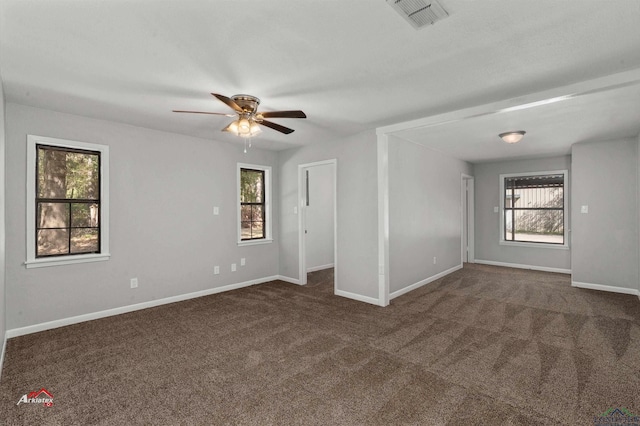 carpeted spare room with ceiling fan