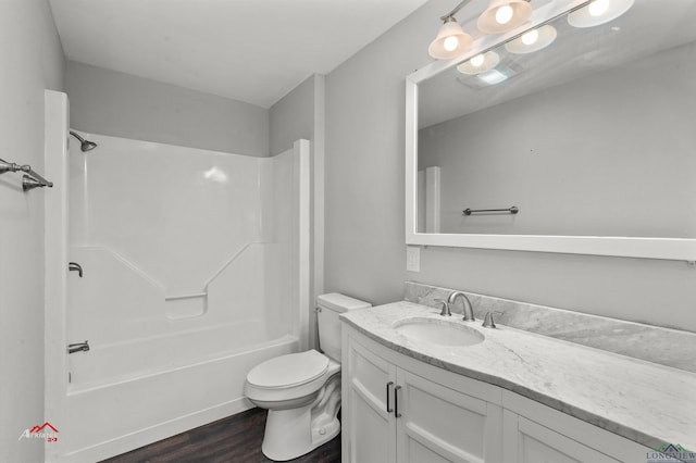 full bathroom featuring shower / tub combination, vanity, hardwood / wood-style flooring, and toilet