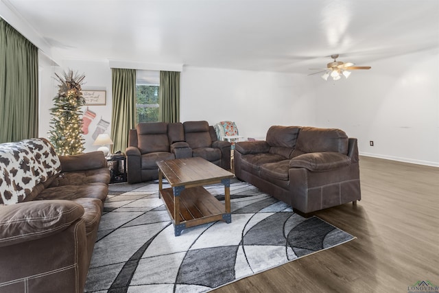 living room featuring ceiling fan and hardwood / wood-style floors