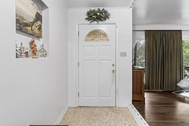 foyer entrance featuring ornamental molding