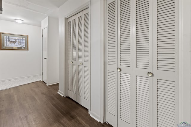 hall with dark wood-type flooring