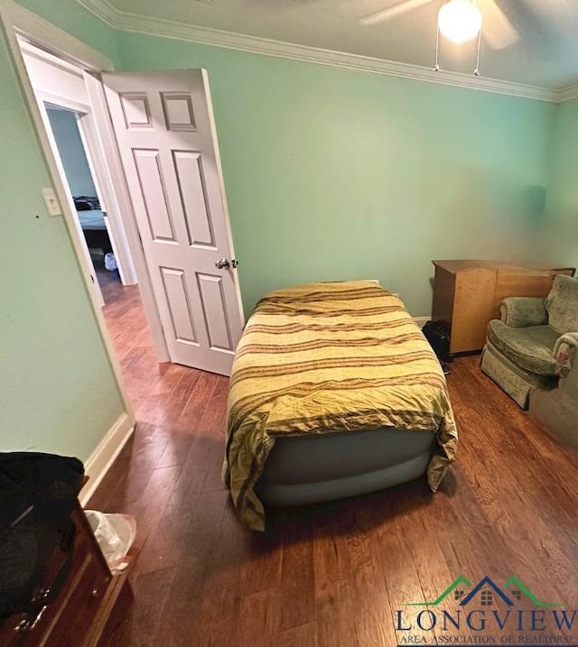 bedroom featuring hardwood / wood-style floors, ceiling fan, and ornamental molding