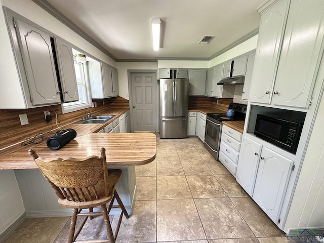 kitchen featuring kitchen peninsula, decorative backsplash, light tile patterned flooring, and stainless steel appliances