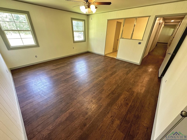 unfurnished room with ceiling fan, plenty of natural light, and dark hardwood / wood-style floors