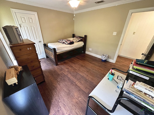 bedroom with dark hardwood / wood-style flooring and ornamental molding