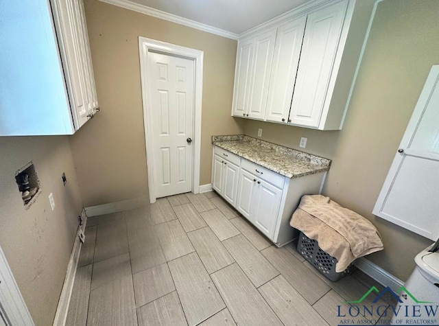 laundry room with cabinets and ornamental molding