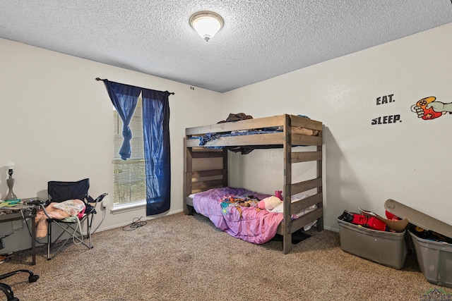 carpeted bedroom featuring a textured ceiling and baseboards