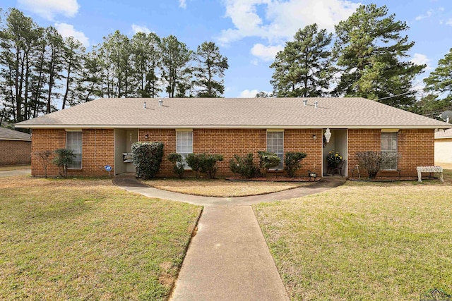 ranch-style house with brick siding, a front yard, and a shingled roof