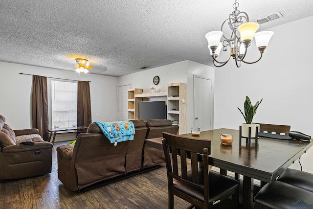 dining room with a textured ceiling, wood finished floors, visible vents, and a chandelier