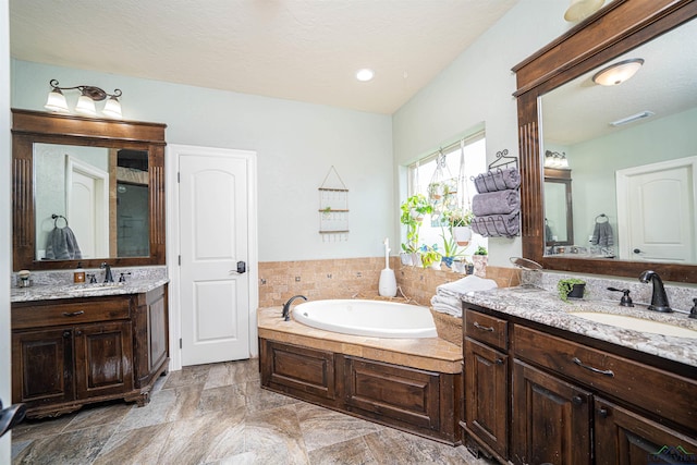 bathroom featuring a tub to relax in and vanity