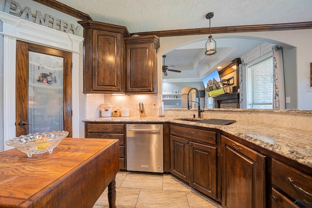 kitchen featuring wood counters, stainless steel dishwasher, dark brown cabinets, ceiling fan, and sink