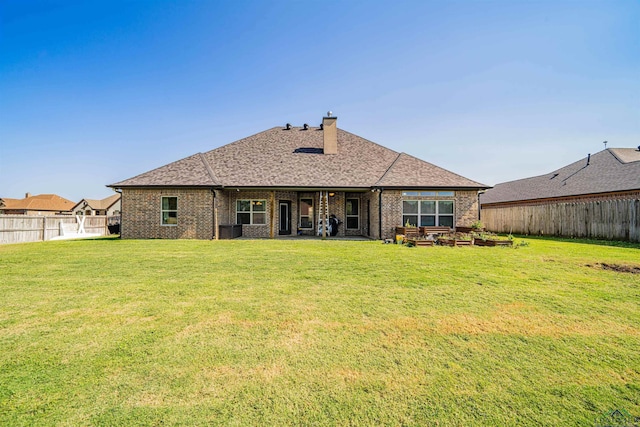 rear view of property with cooling unit and a lawn