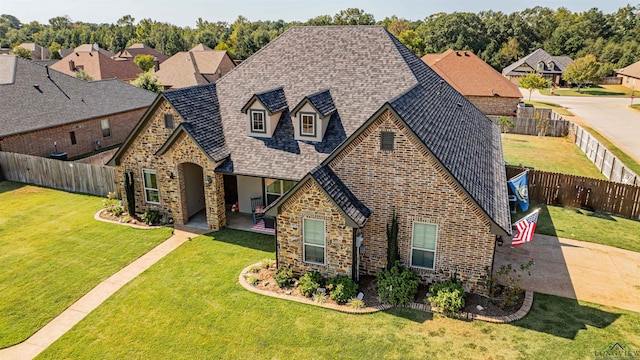 view of front of house with a patio and a front yard