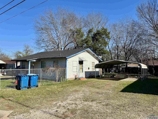 exterior space with a carport and a yard