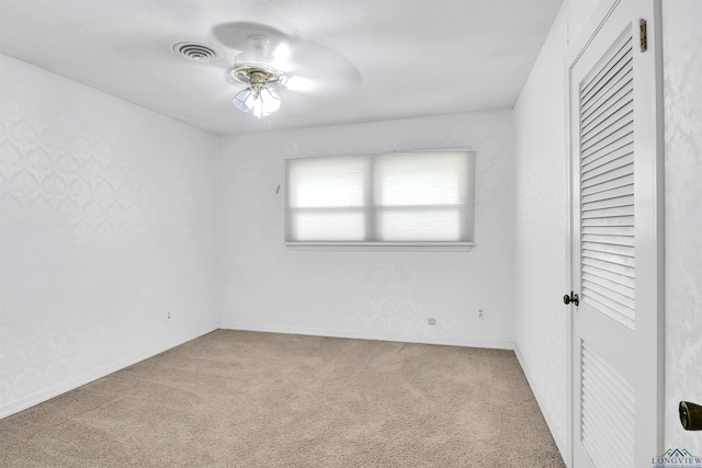 unfurnished bedroom with a closet, visible vents, baseboards, and carpet floors