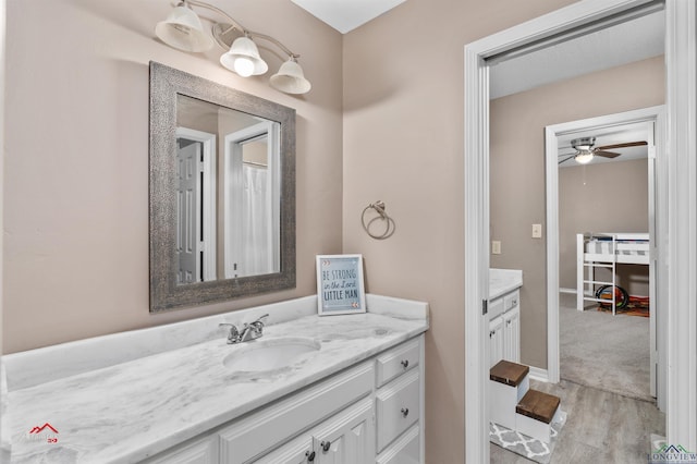 bathroom featuring hardwood / wood-style flooring, ceiling fan, and vanity