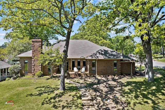 back of property featuring a patio and a lawn