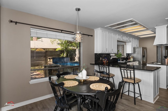 dining area with dark wood-type flooring